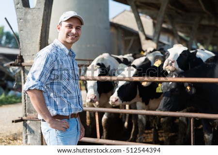 Smiling breeder in front of his cows