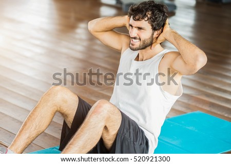 Man working out his abs in a gym