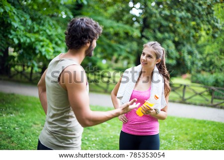 Friends talking while doing fitness outdoor
