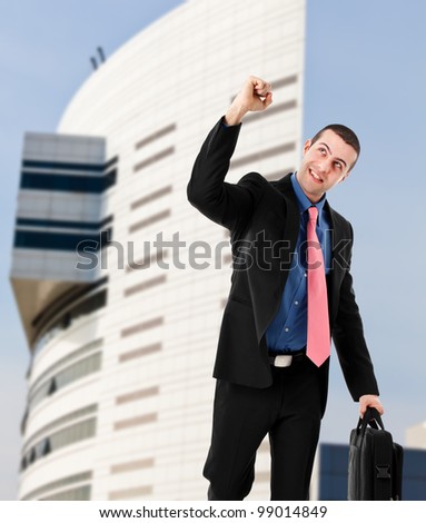Happy businessman obtaining a promotion and going home in a victory pose