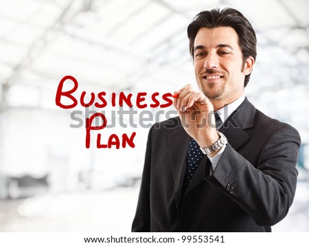 Portrait of a smiling businessman writing \