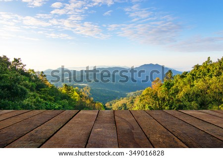 sunny day with landscape and wood terrace