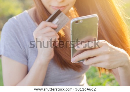 Close up hands using mobile smart phone and holding credit card outdoor, Online shopping,