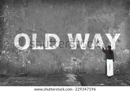 businesswoman drawing old way on the wall