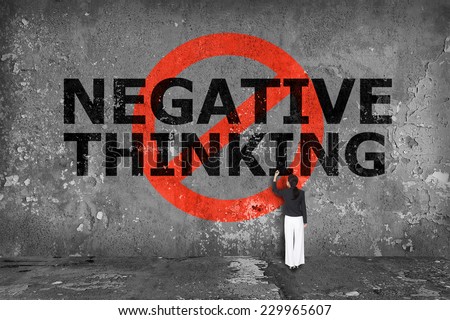 businesswoman drawing negative thinking on the wall