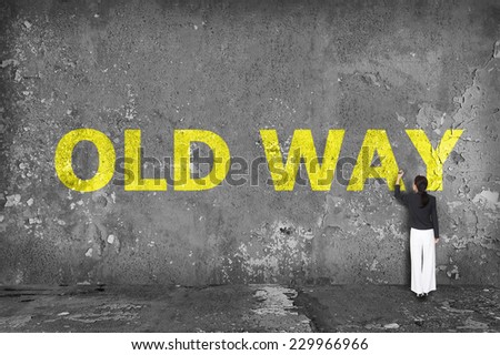 businesswoman drawing old way on the wall