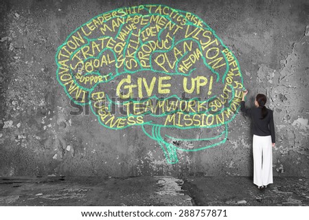 woman writing give up with brain on wall