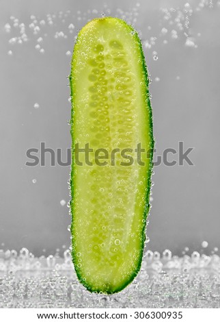 Cucumber slice in water with bubbles of gas. design element