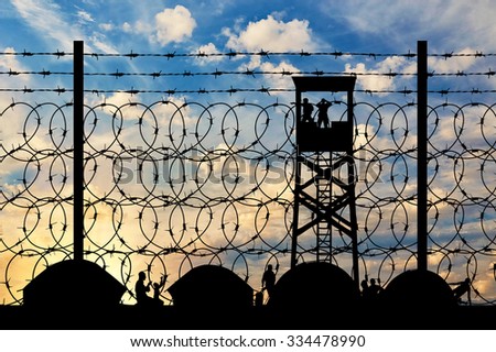 Concept of refugee. Silhouette refugee camps with tents, amid watch tower and a barbed wire fence