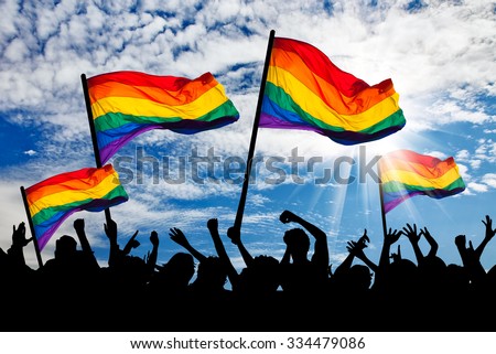 Silhouette of a parade of gays and lesbians with a rainbow flag