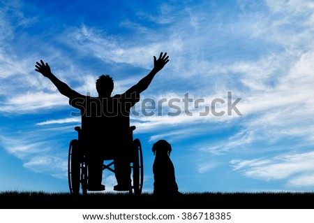Concept of disability and disease. Silhouette happy disabled person in a wheelchair beside the dog on the background of the sky