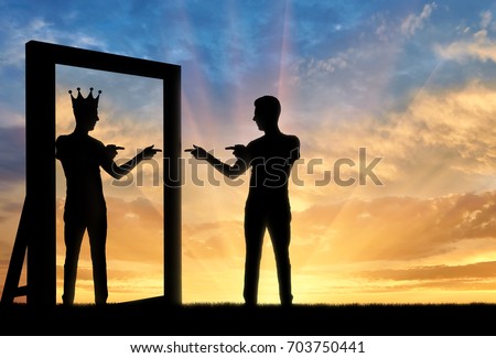 Concept of a narcissistic and egoistic man. Silhouette of a man standing, motivating himself at the mirror and sees in the reflection of himself with a crown on his head