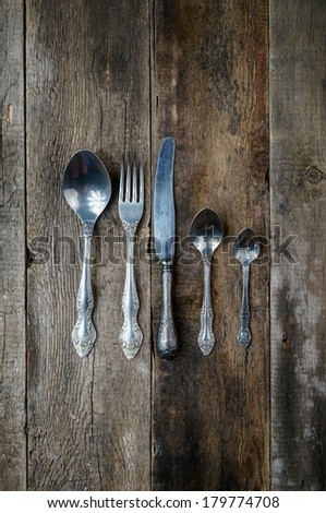 Fork spoon knife on old wooden background