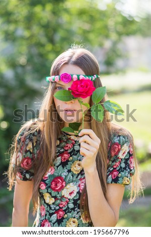 Closeup portrait of a attractive girl hidden face with flower. focus on face
