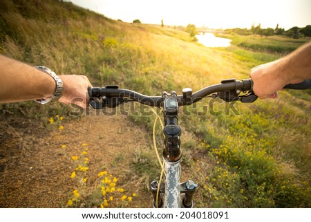 Bike handle bar with lake and sunshine in the background. focus on bike handle bar