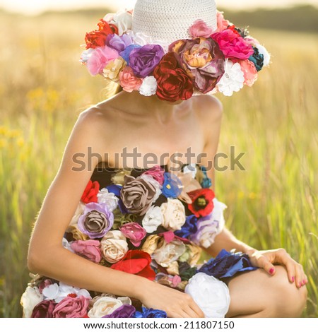 Romantic young woman in hat and funny dress. focus on hat, shadows on shoulders