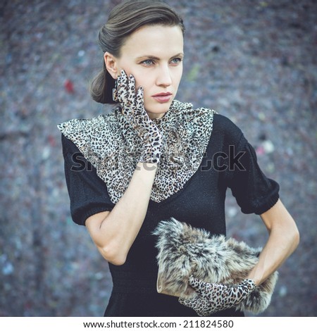 Fashion woman in leopard accessories. toned old retro dark image