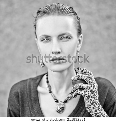 Portrait of beautiful young woman with perfume bottle. black and white