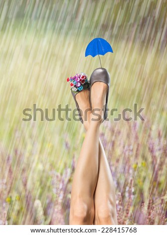 Sexy woman legs in funny shoes in raining. Shoe care concept