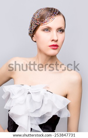 Evening party woman. Fashion photo of beautiful woman with creative hairdo with bead strands and evening dress