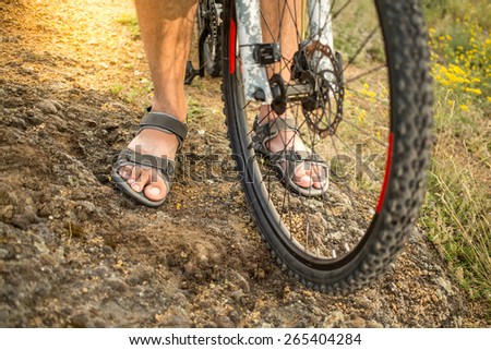 Cyclist riding mountain bike on rocky trail. selective focus on wheel and foot