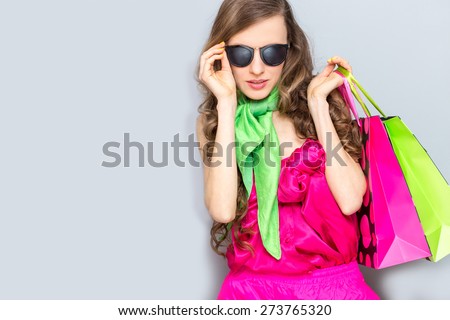 Fashion woman with shopping bags and wearing sunglasses