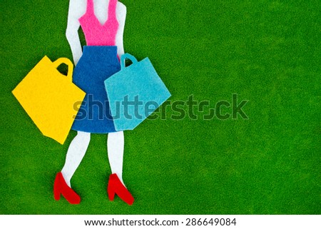 Happy shopping concept. Woman shopping silhouettes over green background