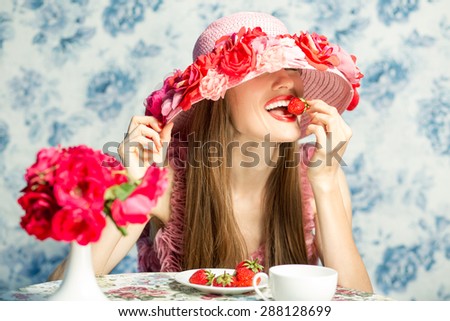 Sexy woman eating strawberry in restaurant on vacation. Sensual red Lips. red manicure and lipstick. Desire