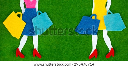 Happy shopping concept. Woman shopping silhouettes over green background with copy space between