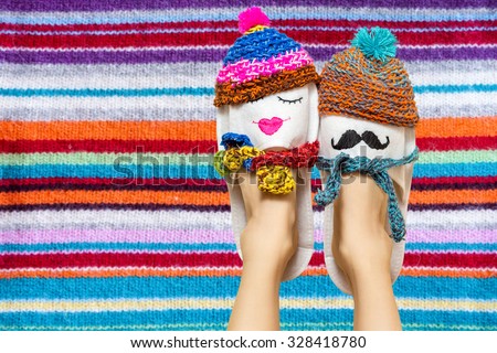 Young couple in love concept. Funny woman legs in slippers over colorful vibrant background