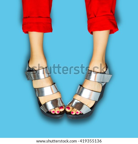 Female legs wearing summer hights over blue background