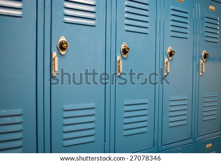 Blue school lockers in a hallway with locks from an angle