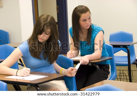 teenage girls cheating on a test