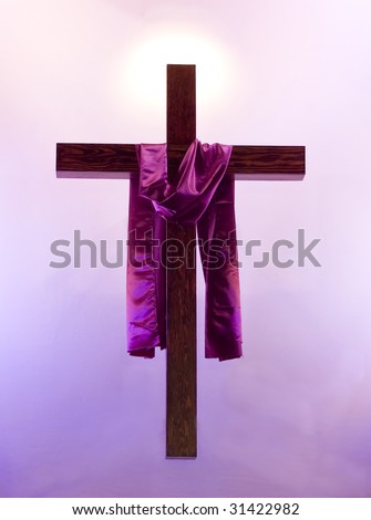 Easter holy cross with purple sash hanging with a glowing background