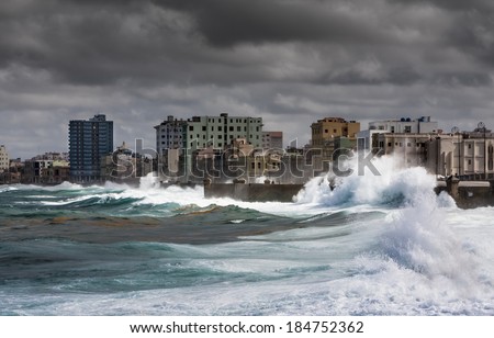 HAVANA, CUBA - DECEMBER 8, 2011: Stormy weather in Havana. The Caribbean waves are rolling over the walls of Malecon.