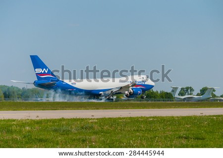 KIEV, UKRAINE - MAY 20, 2015: Silk Way Airlines cargo Boeing 747-8F touching the ground and slows with smoke from under the wheels at Borispol International Airport on May 20, 2015 in Kiev, Ukraine.