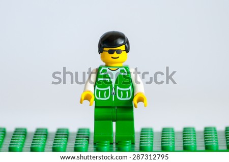KIEV, UKRAINE - JUNE 14, 2015: Studio shot of Lego minifigure guy in green jacket. Legos are a popular line of plastic construction toys manufactured by The Lego Group, a company based in Denmark.