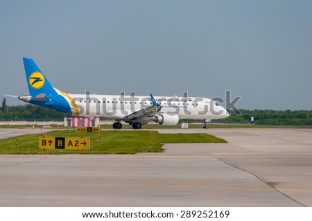 BORYSPIL, UKRAINE - MAY, 20, 2015: Ukraine International Airlines Embraer 190 taxiing at Boryspil International Airport, Kiev, Ukraine. Borispol - Ukraine\'s largest airport