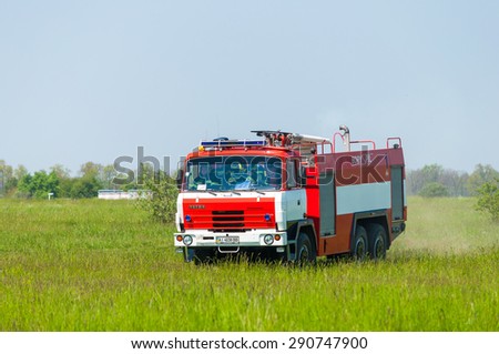 BORYSPIL, UKRAINE - MAY, 20, 2015: Fire-brigade on firetruck Tatra ride on alarm for instruction for fire suppression and mine victim assistance at Boryspil International Airport, Kiev, Ukraine