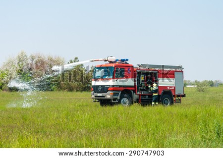 BORYSPIL, UKRAINE - MAY, 20, 2015: Fire-brigade on Fire Engine Mercedes using a water cannon during a training event at Boryspil International Airport, Kiev, Ukraine