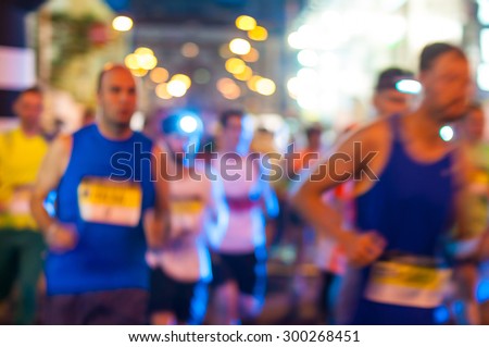 Blurred Runners shortly after the start at the night run.  Bokeh background.