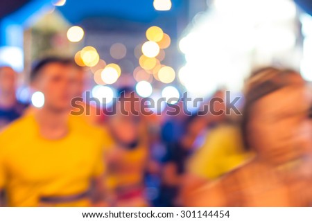 Blurred abstract crowd and Lights. Night marathon runners. Sport background.