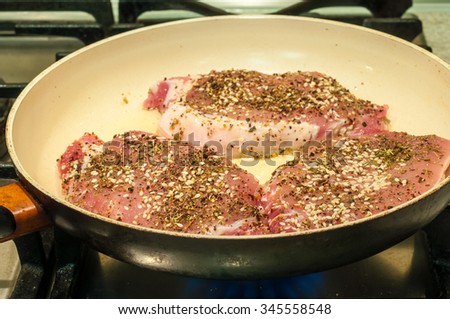 Healthy lean grilled medium-rare beef steak with spice in frying pan. Cooking process. Selective focus.