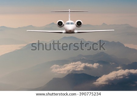 Luxury Airplane fly over clouds and Alps mountain on sunset. Front view of a big passenger or cargo aircraft, business jet, airline. Travel concept. Empty space for text