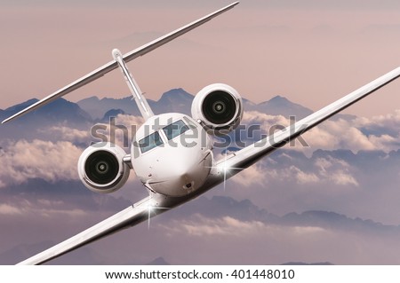 Airplane fly over clouds and Alps mountain on sunset. Front view of a big passenger or cargo aircraft, business jet, airline. Transportation, travel concept