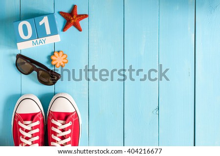 May 1st. Image of may 1 wooden color calendar on blue background.  Spring day, empty space for text.  International Workers' Day