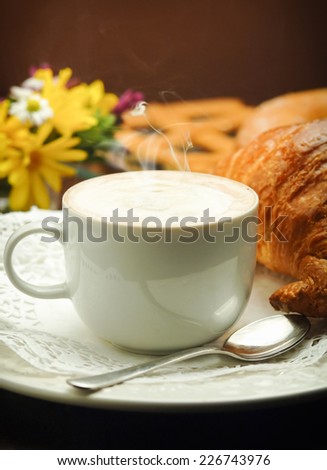 Continental breakfast with cappuccino and croissant