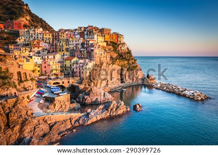 Manarola, Liguria, Italy. The wonderful Manarola village as you can see it from the mountain above. Quiet sky and peaceful sea, during sunset.