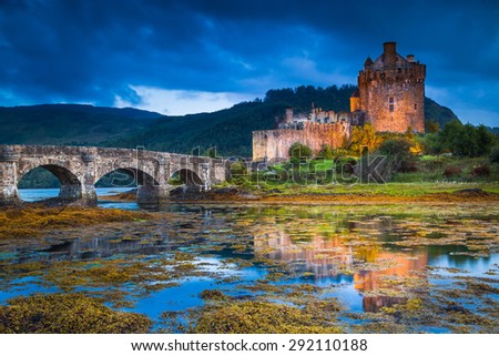 Eilean Donan Castle, Scotland, reflecting itself into the water during evening.