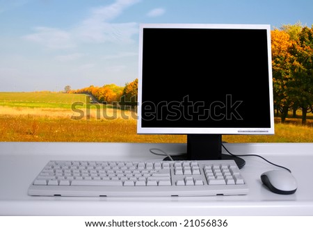 PC with black desktop and autumn trees background